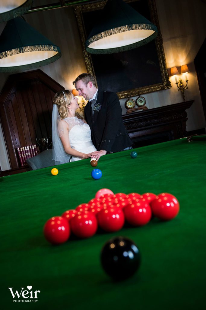 Couple by snooker table