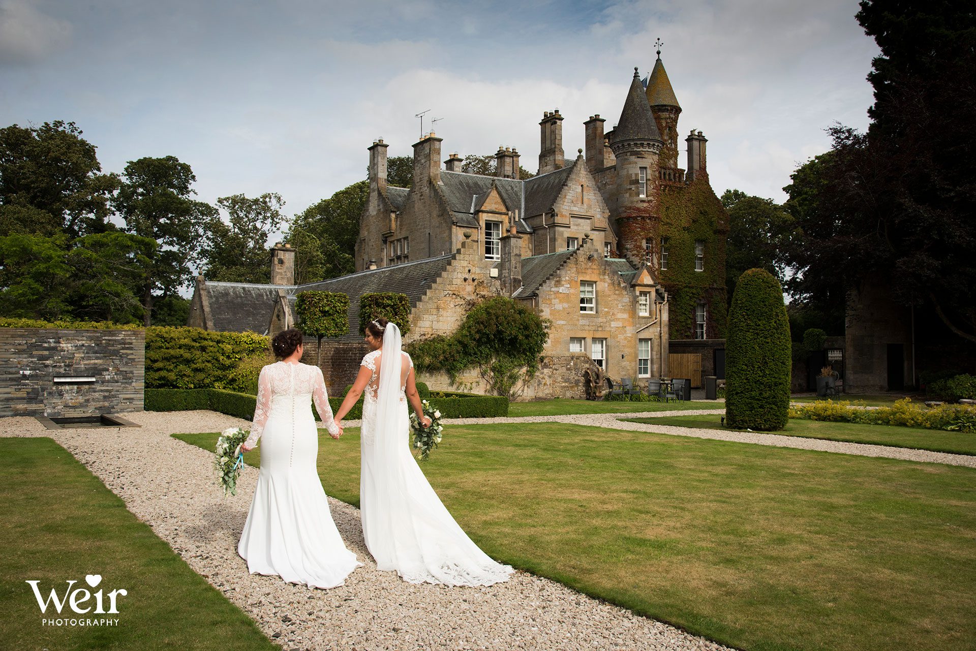 Bride and bride in grounds of Carlowrie Castle