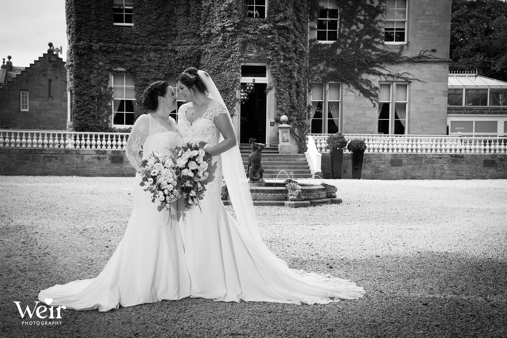 Bride and Bride in front of Carlowrie Castle