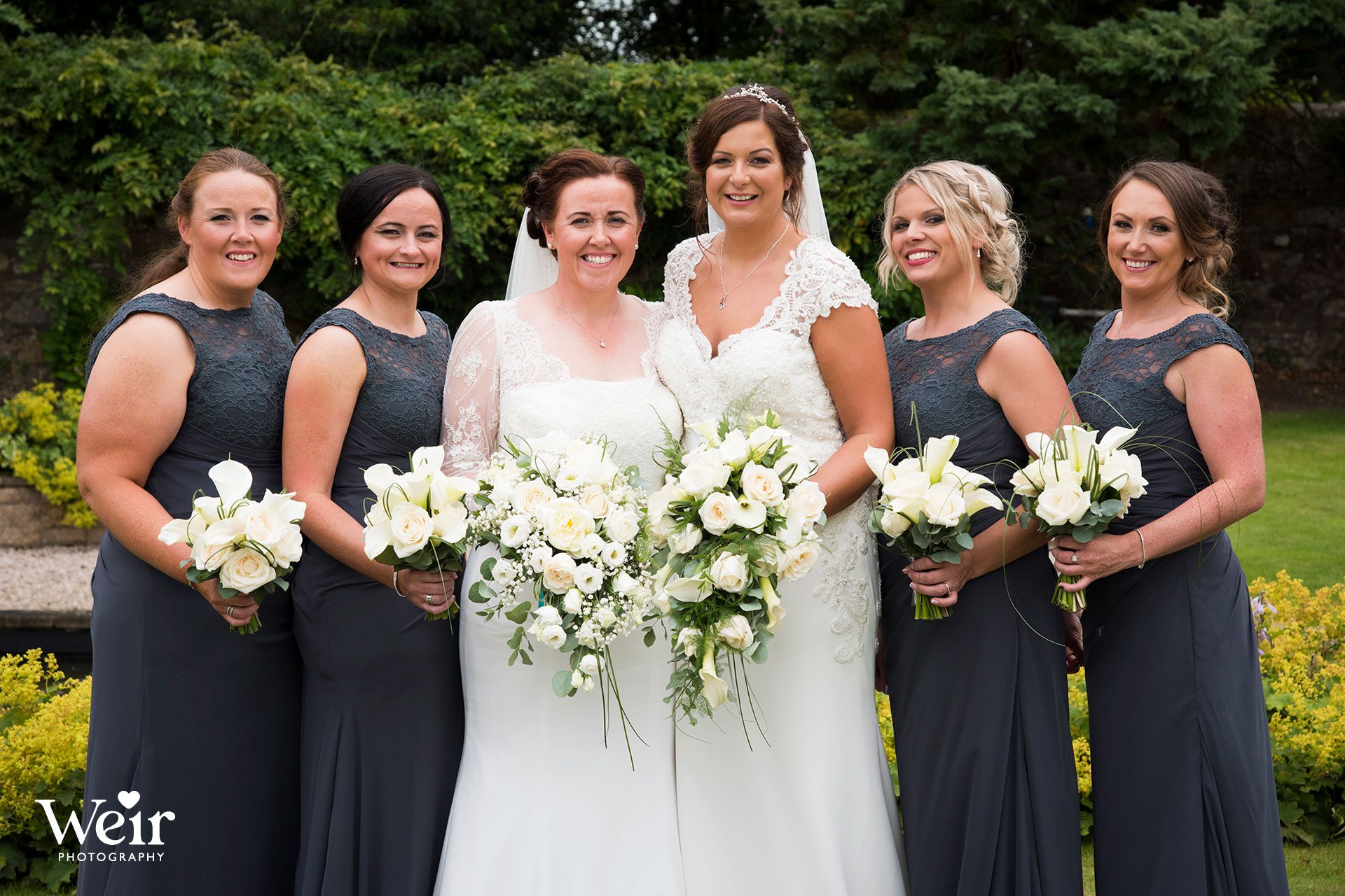 Brides with bridesmaids in grounds of Carlowrie Castle