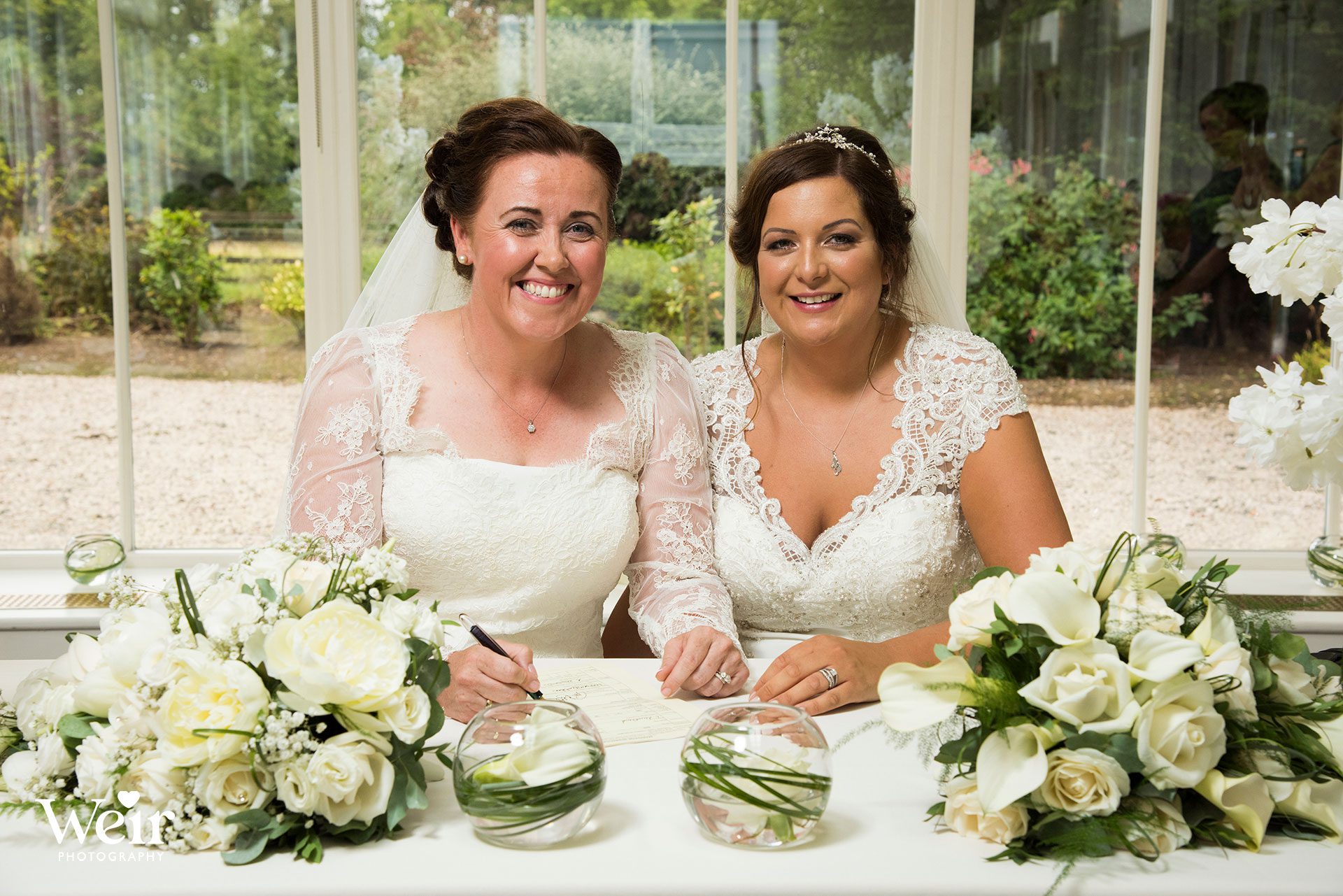 Brides signing register at Carlowrie Castle