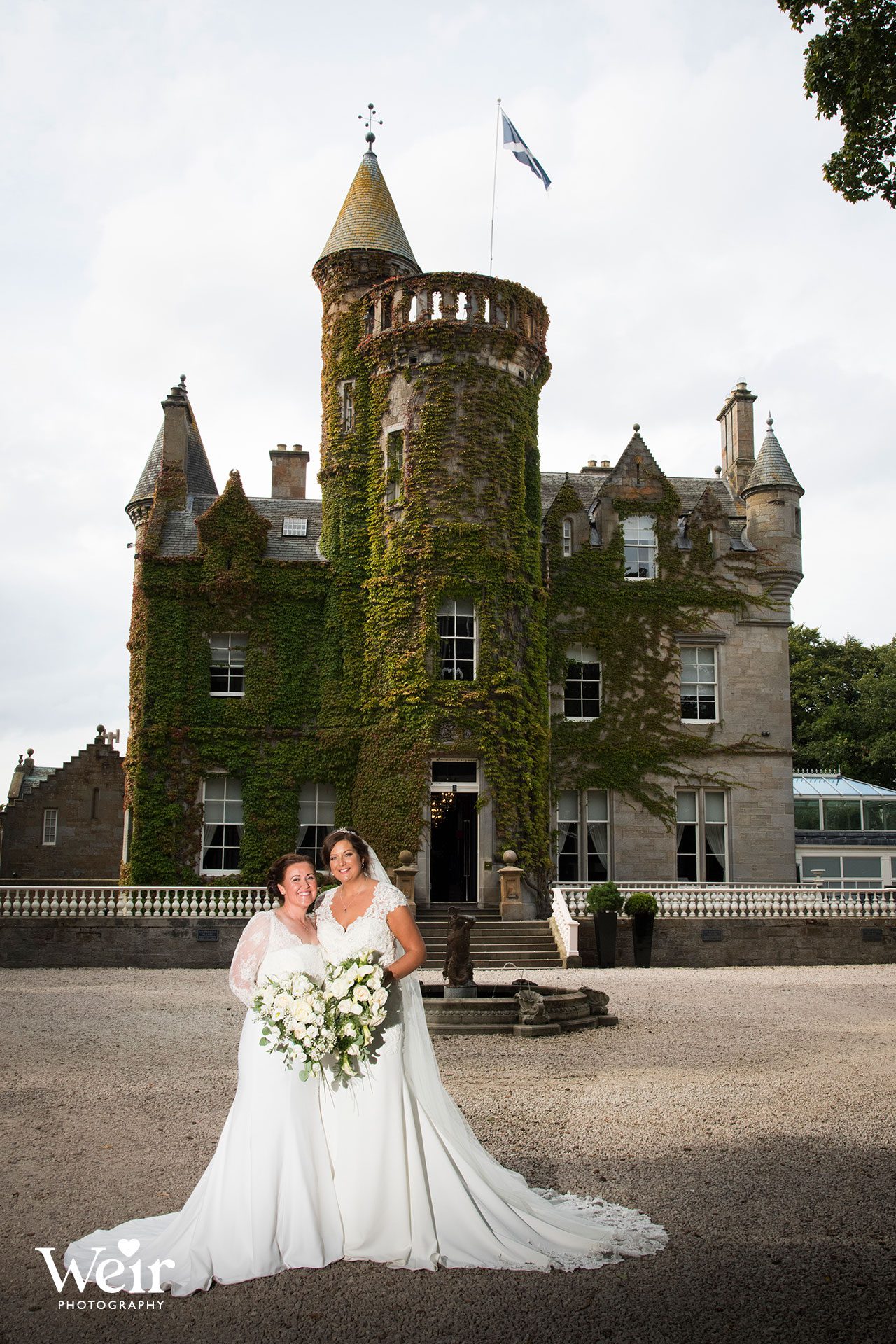 Brides in front of Carlowrie Castle