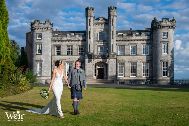 Bride and Groom walking in front of Airth Castle